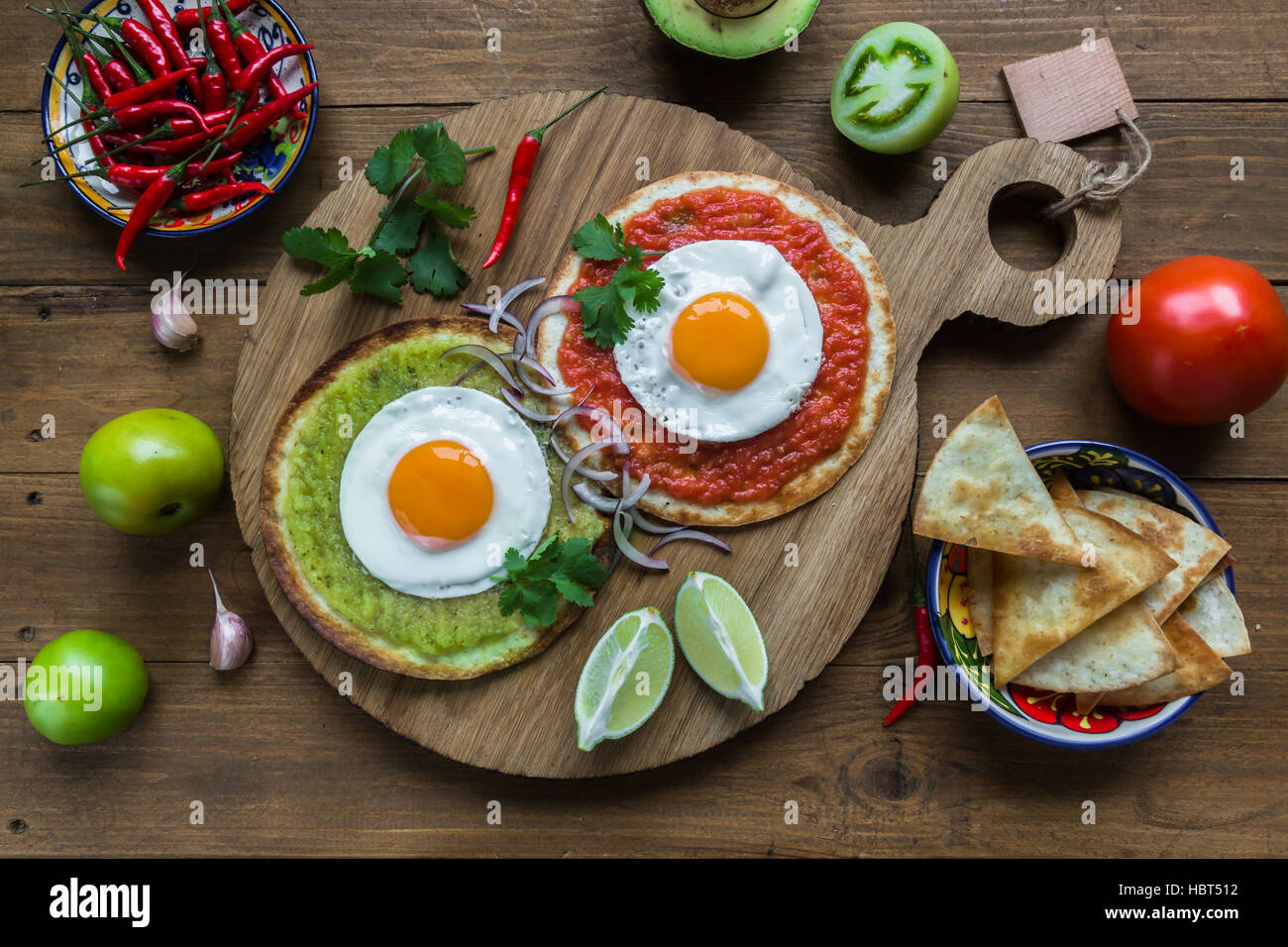 huevos divorciados, fried eggs on corn tortillas with salsa verde and  roja, mexican breakfast Stock Photo