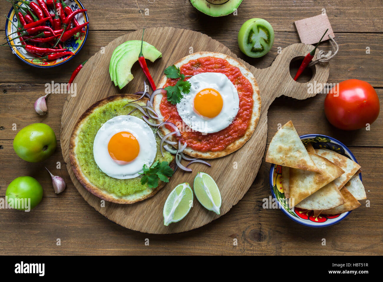 Divorced eggs, fried on corn tortillas with salsa verde and roja Stock