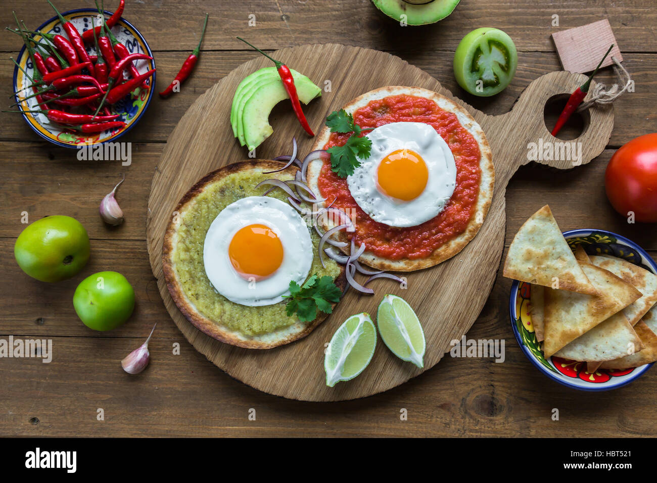 huevos divorciados, fried eggs on corn tortillas with salsa verde and