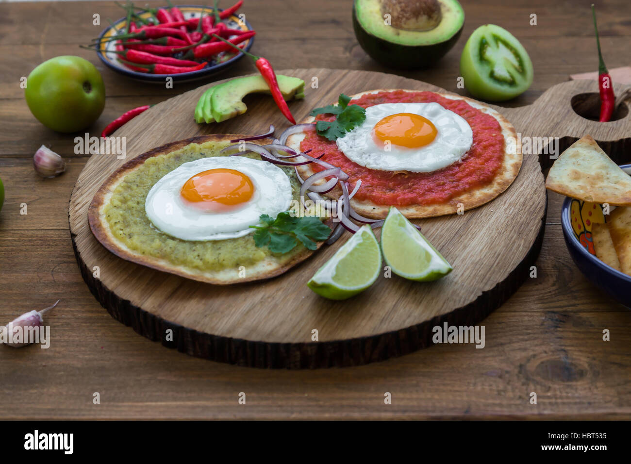Huevos divorciados, delicious food with eggs, fresh salad and herbs  spicy  herby sauce Stock Photo