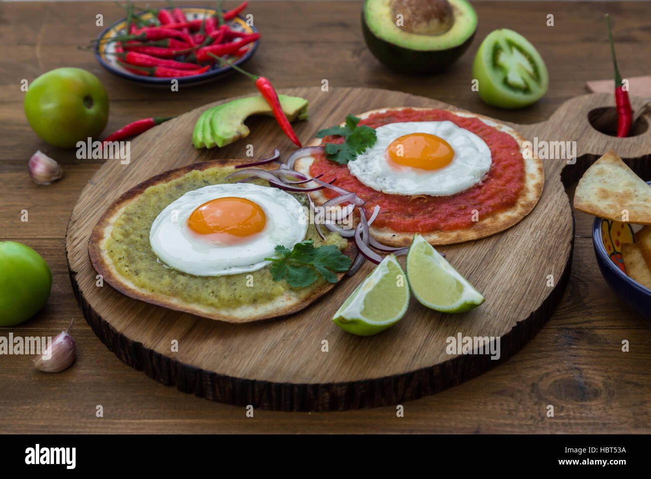 Huevos divorciados, delicious food with eggs, fresh salad and herbs  spicy  herby sauce Stock Photo