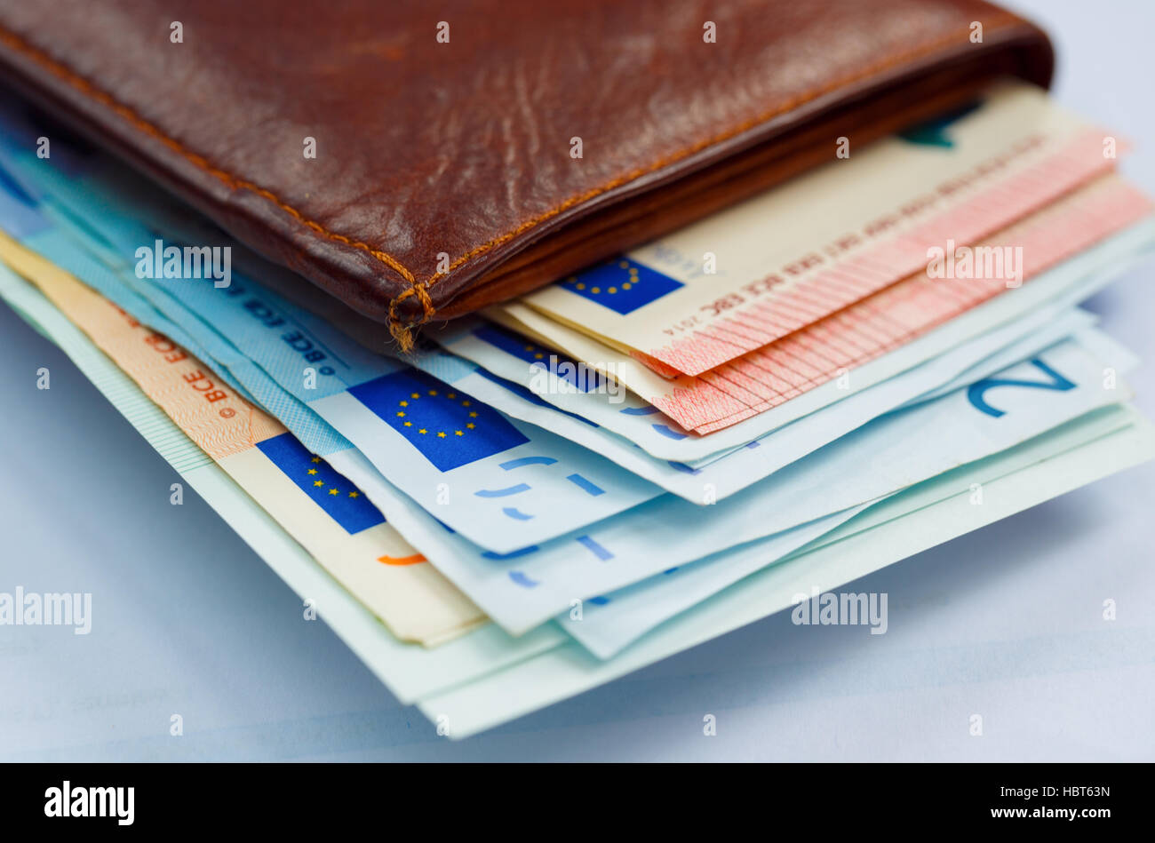 Brown leather wallet with money euro inside it Stock Photo