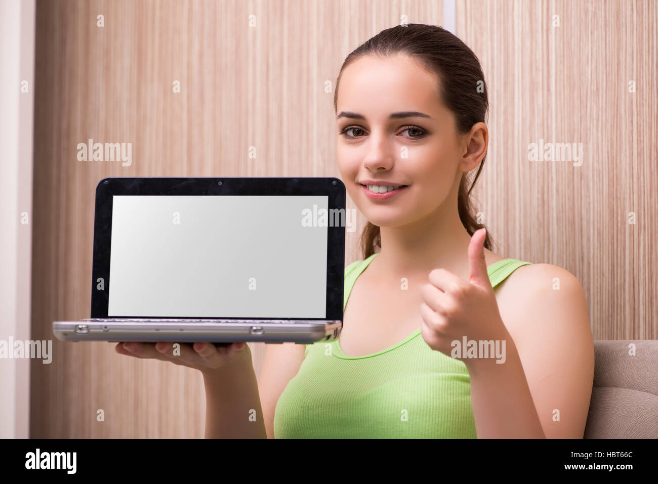 Young woman working at laptop at home Stock Photo - Alamy