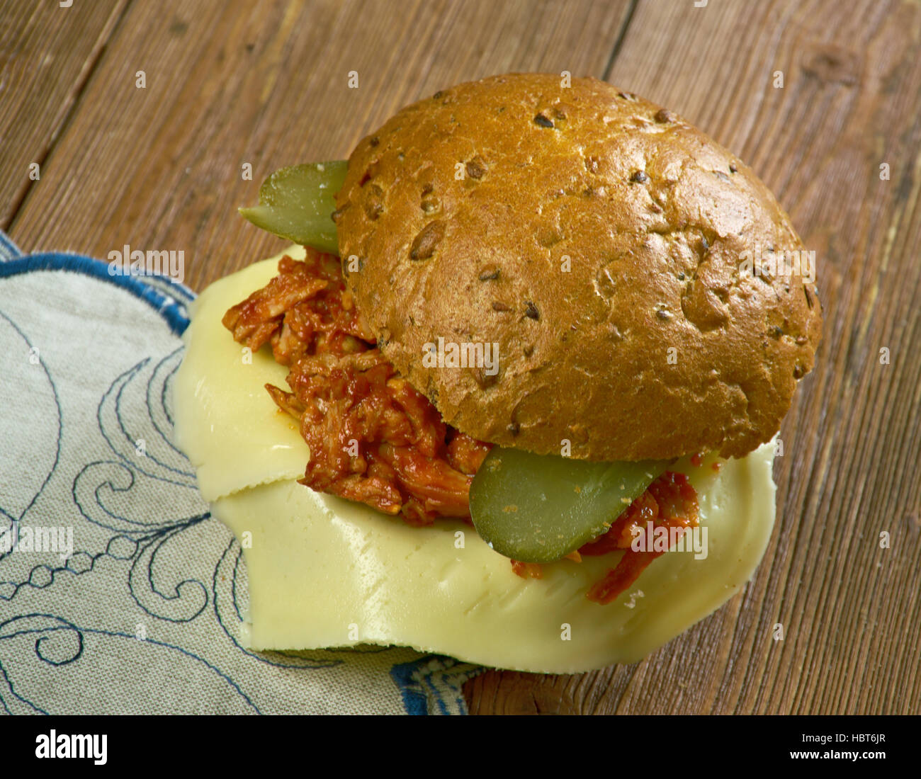 Tavern sandwich -  sandwich originally consisting of unseasoned ground beef on a bun, mixed with sauteed onions, and sometimes topped with pickles. Stock Photo