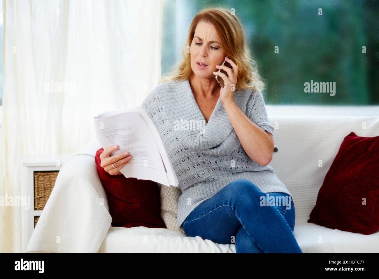 Woman talking on the phone to advisor Stock Photo