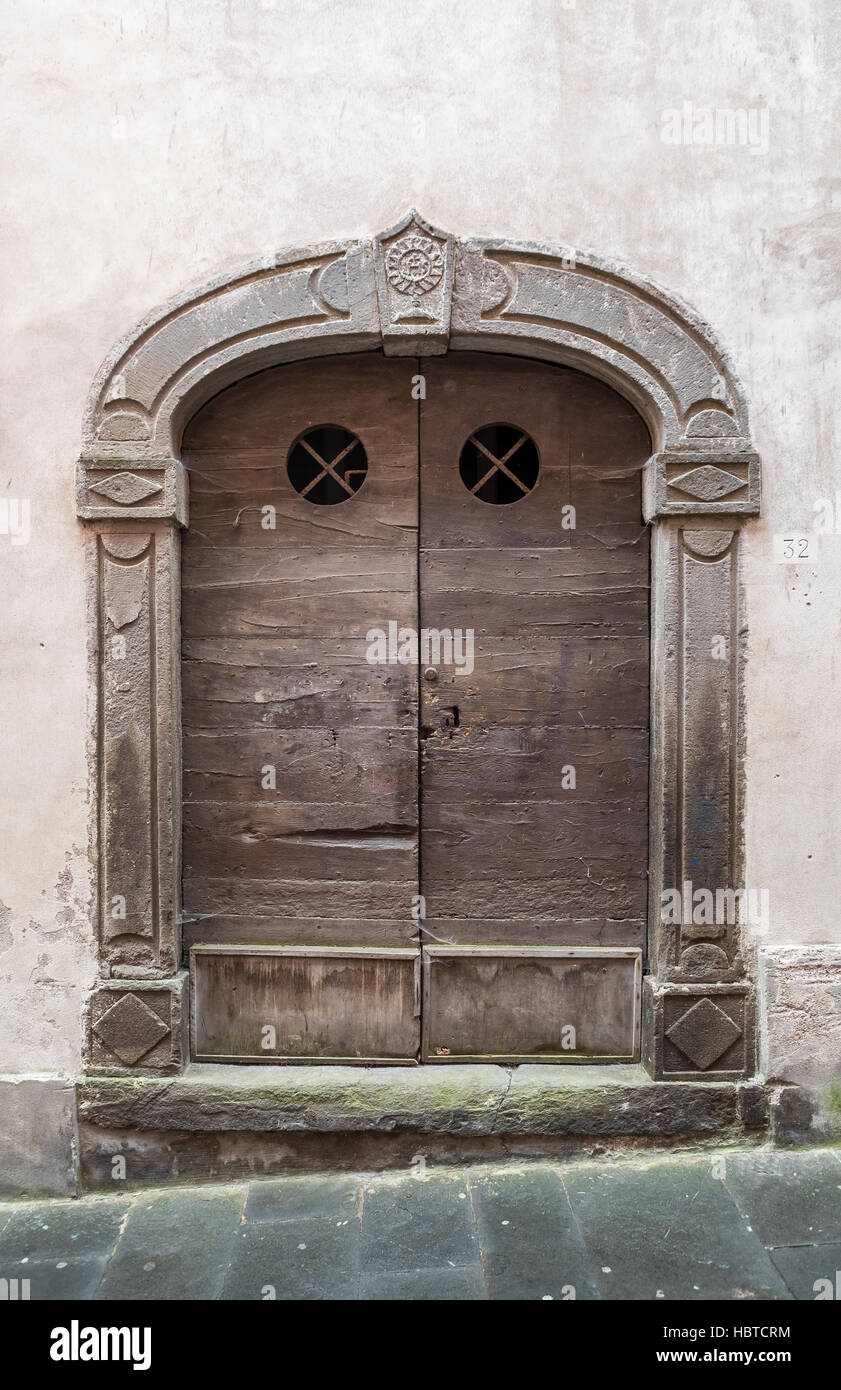 Wooden front doors of Barga. The medieval hilltop town of Barga, in Tuscany, Italy. Stock Photo
