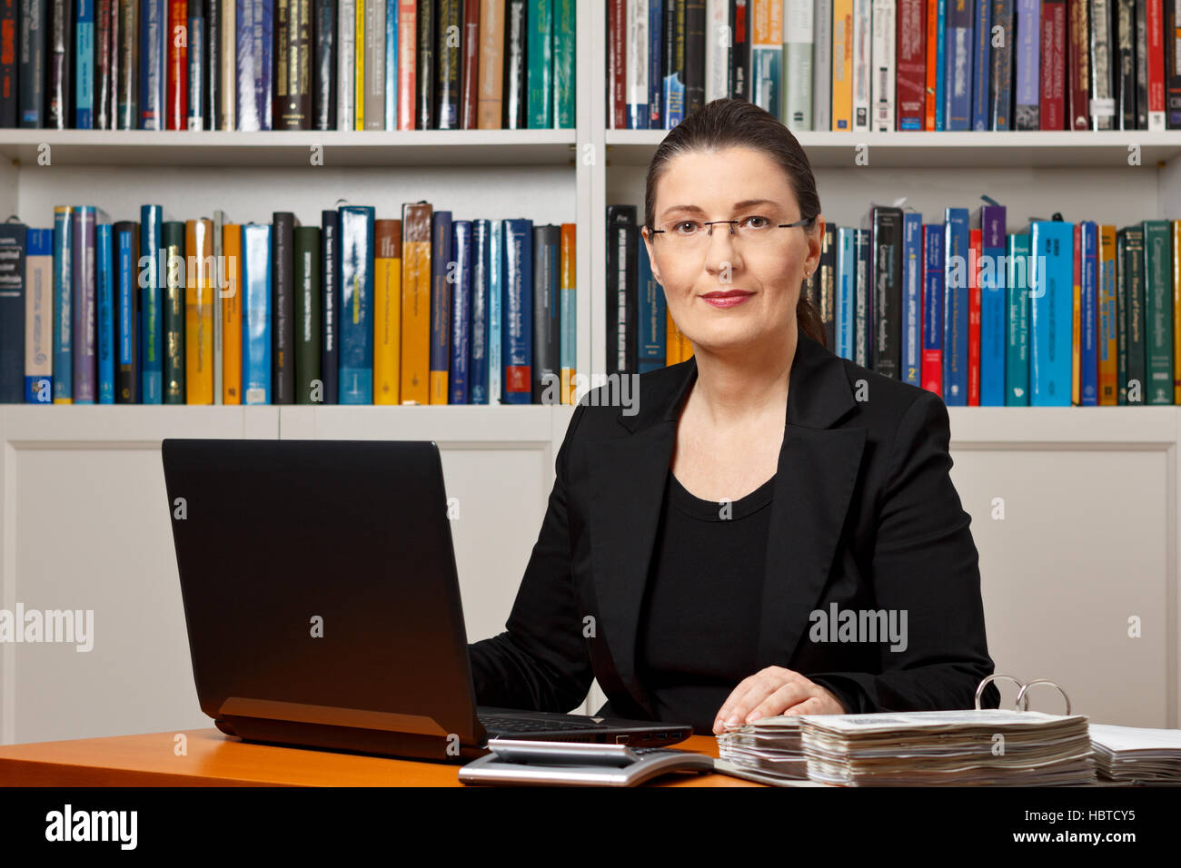 Mature woman in an office or library, tax or financial accountant, consultant, adviser or counselor Stock Photo
