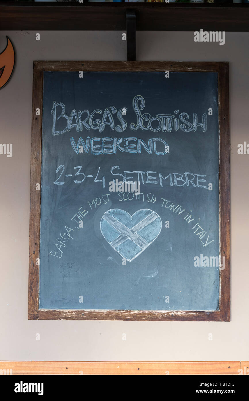 Barga Scottish Weekend festival advertised in the town's Irish Pub. The medieval hilltop town of Barga, in Tuscany, Italy. Stock Photo