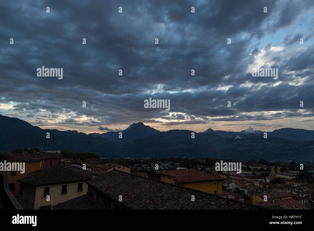 Pania della Croce mountain and the medieval hilltop town of Barga from the terrace of Collegiate Church of San Cristoforo, Barga in Tuscany, Italy. Stock Photo