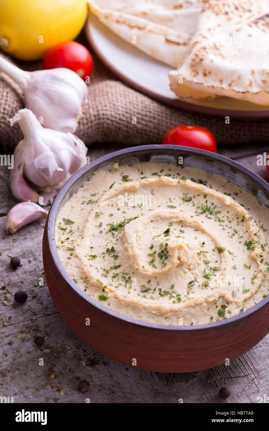 Humus in homemade bowl chapati and vegetable. Stock Photo