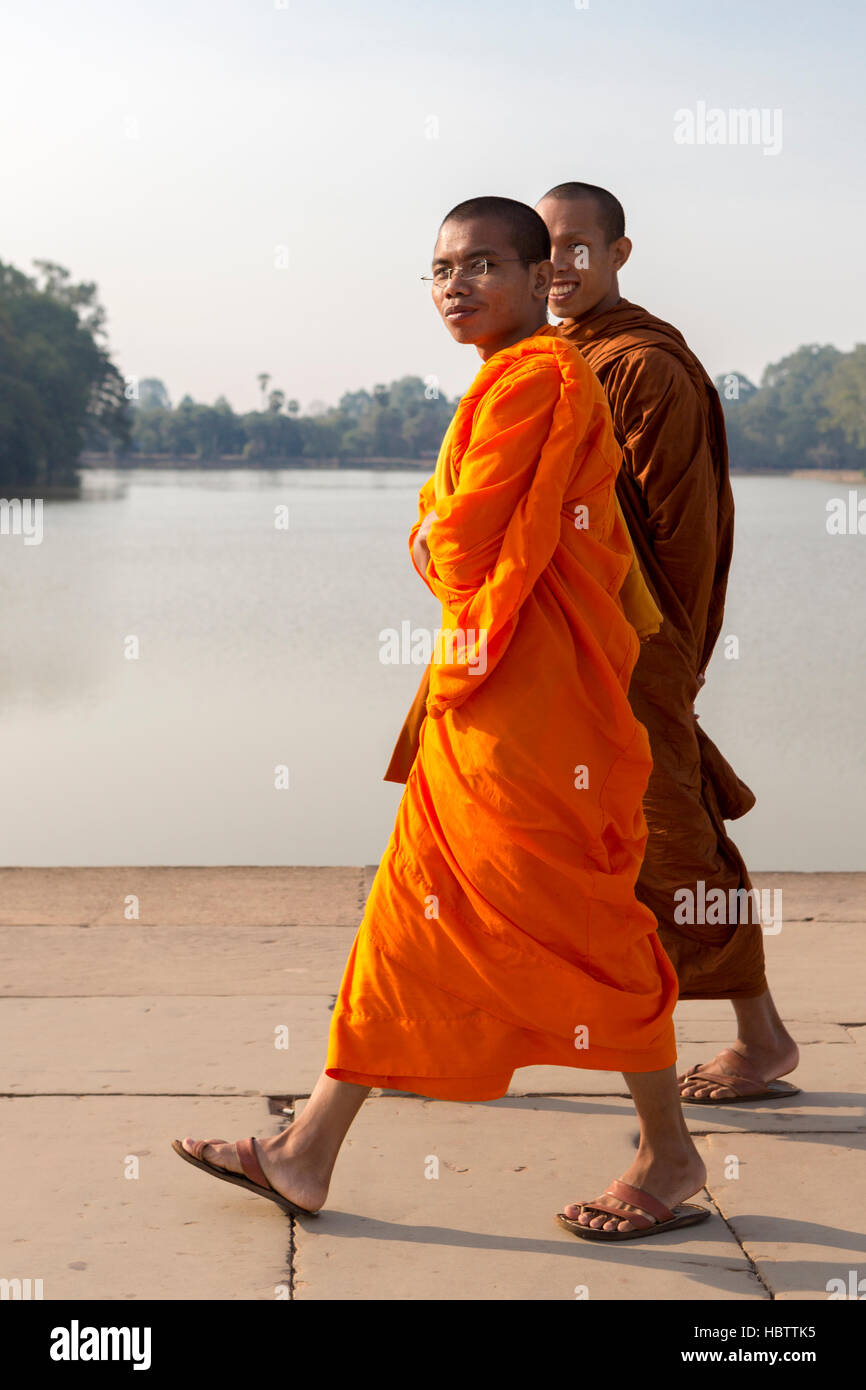 Cambodian monks smiling and walking to Angkor Wat Temple Stock Photo