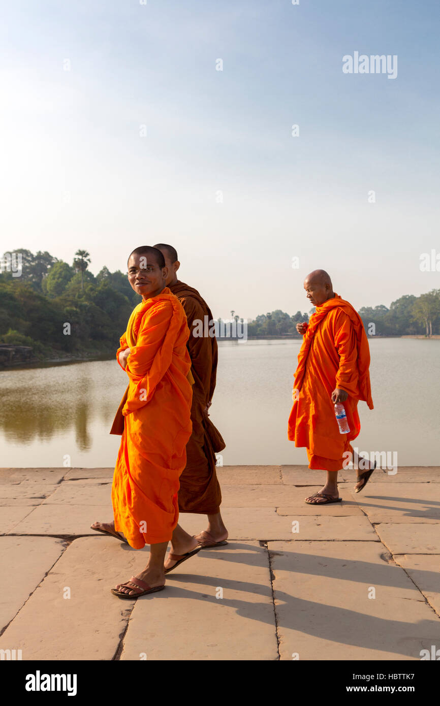 Cambodian monks smiling and walking to Angkor Wat Temple Stock Photo
