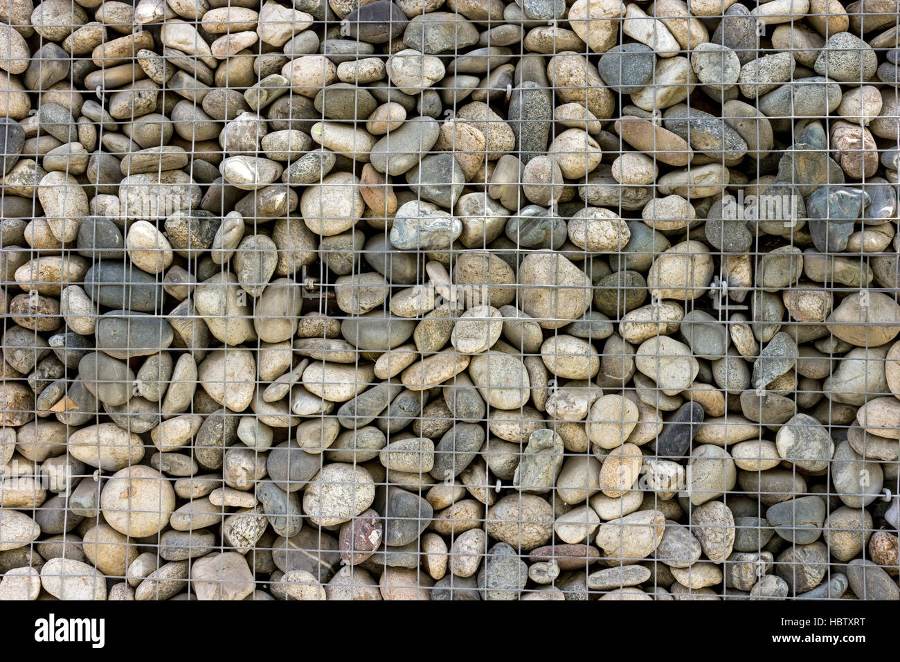 Backgrounds collection - The decorative stone wall built of sea pebbles Stock Photo