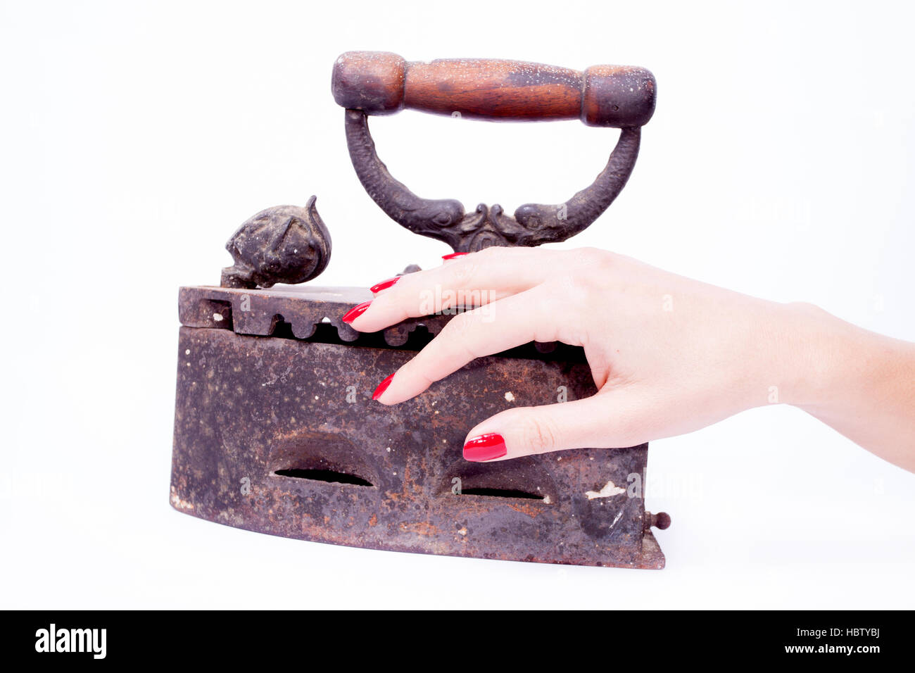 Woman hand holding vintage iron Stock Photo