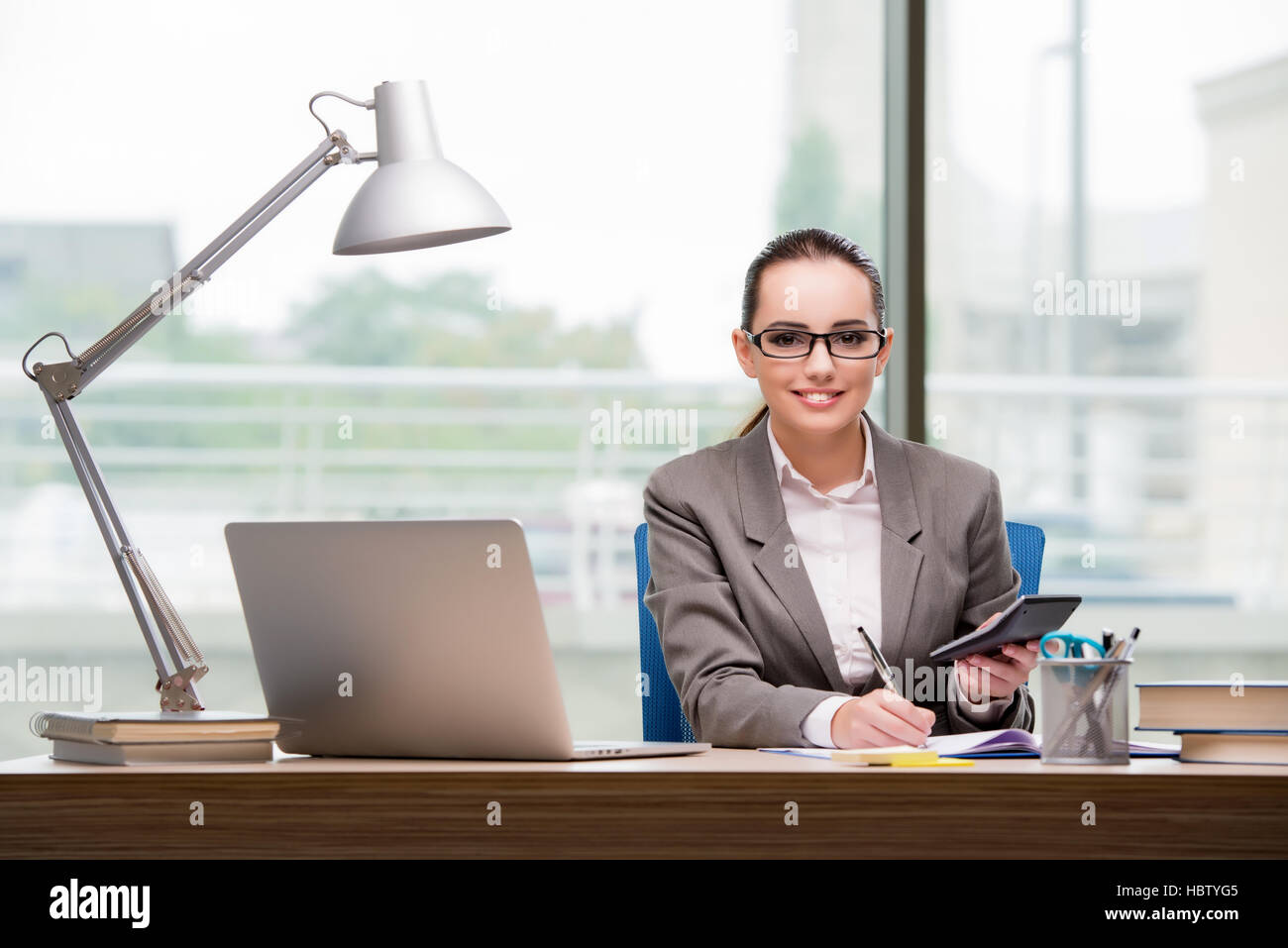 The businesswoman working at her desk Stock Photo - Alamy