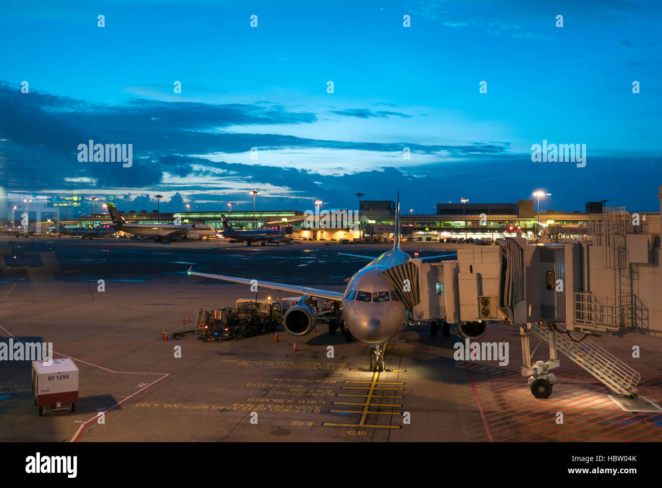 Airplanes at Singapore Changi Airport International terminal with sunrise. Stock Photo