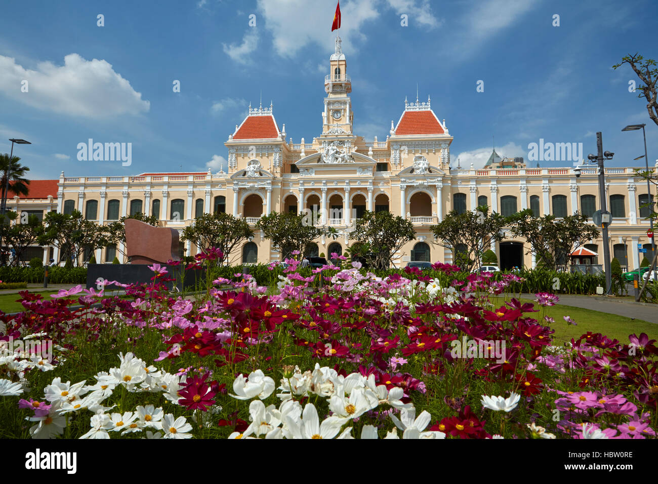 Flowers and historic People's Committee Building (former Hotel de Ville de Saigon), Ho Chi Minh City (Saigon), Vietnam Stock Photo