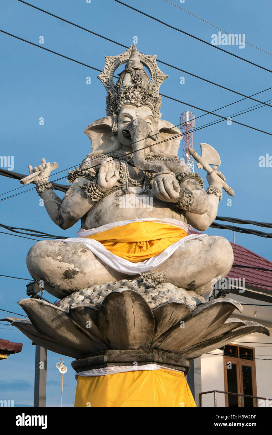 Massive statue of Ganesh in small city in Bali with electrical wires. Indonesia Stock Photo