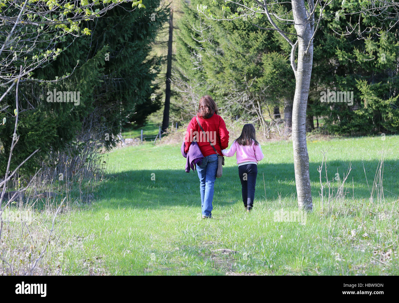 young mother and her little girl walking in the mountains hand in hand Stock Photo