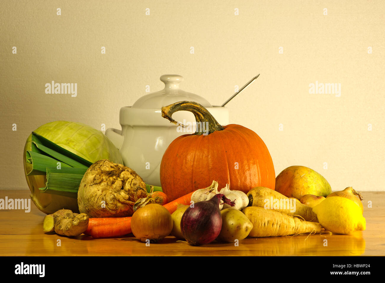 The beauty of fall as a still life with soup vegetables and a soup tureen on a wooden table Stock Photo