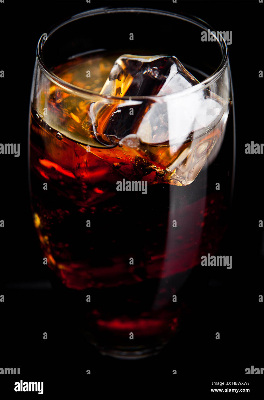 Glass of cold cola soda drink with ice cubes on black background Stock ...