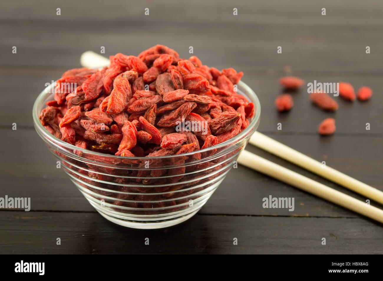 Goji berries in a bowl with Chinese chopsticks Stock Photo