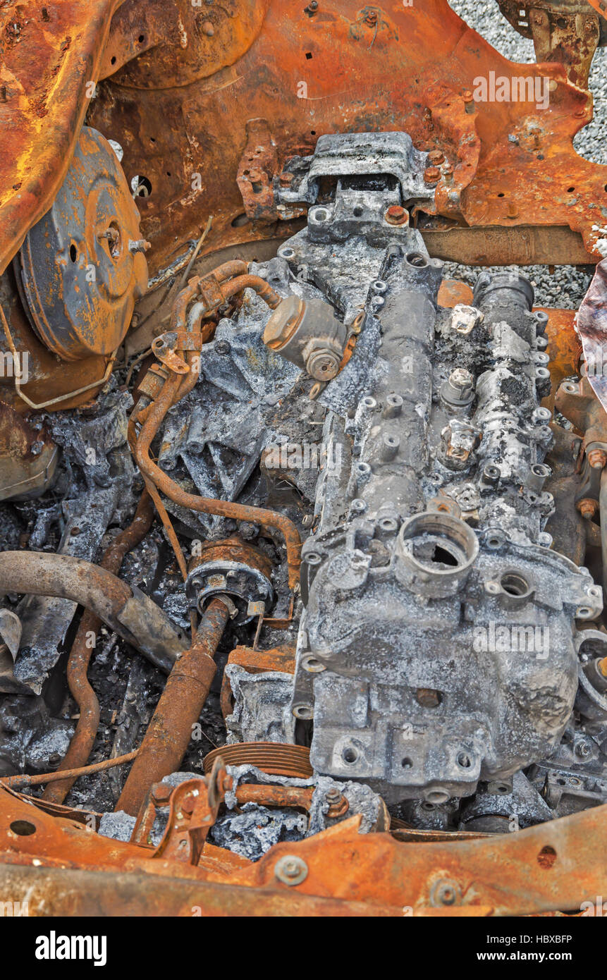 Destroyed and rusty car engine in a terrorist explosion and fire Stock