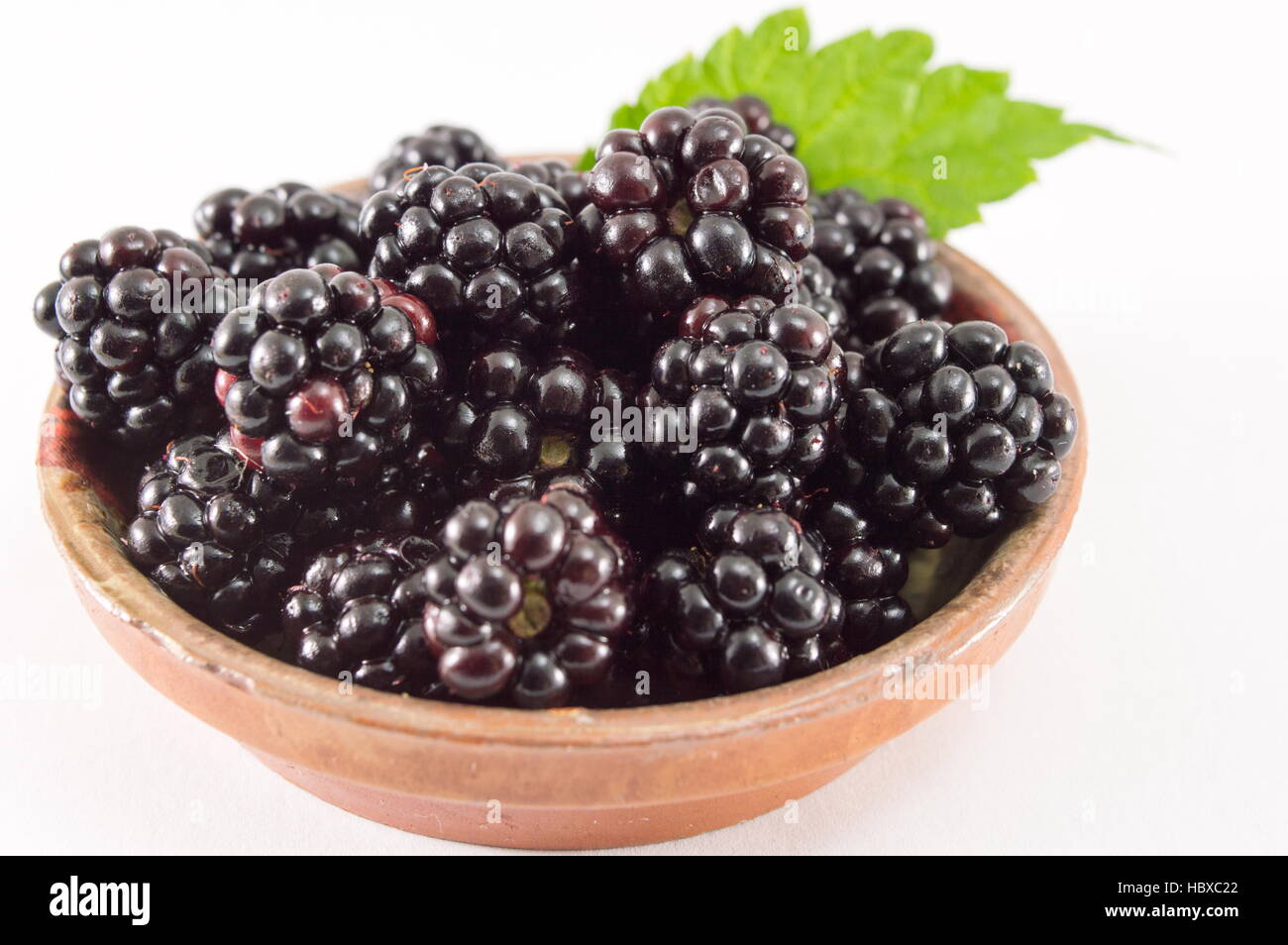 bunch of fresh juicy blackberries on a plate isolated Stock Photo