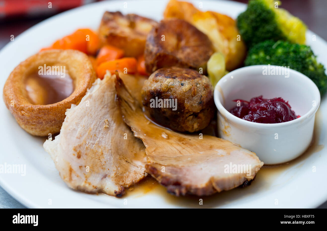 Roast dinner with christmas cracker in the background to reflect a christmas dinner Stock Photo
