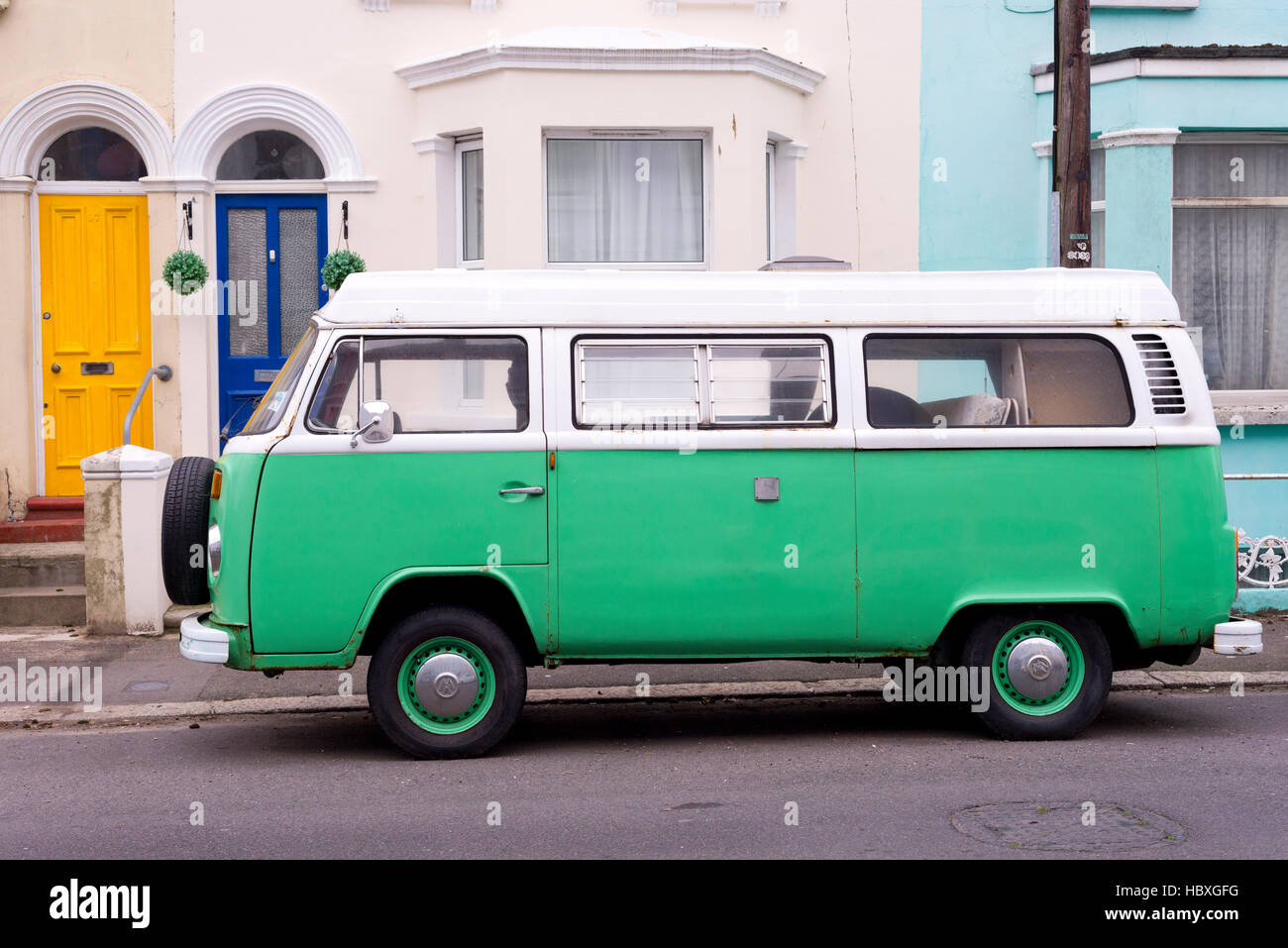 Green VW camper van parked in the street Stock Photo