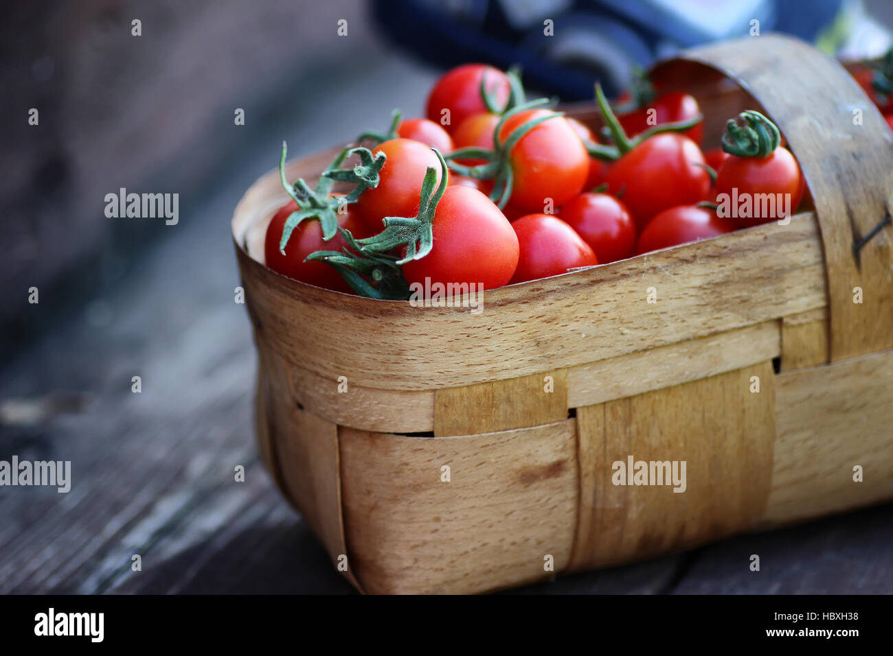 rustic basket of tomato fresh on wood Stock Photo - Alamy