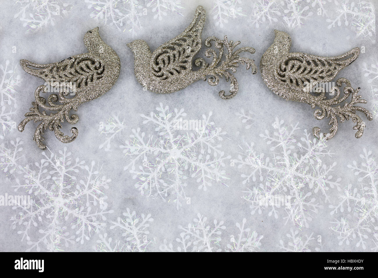 Christmas doves and snowflakes decorated as a Christmas greeting background in white and gold Stock Photo