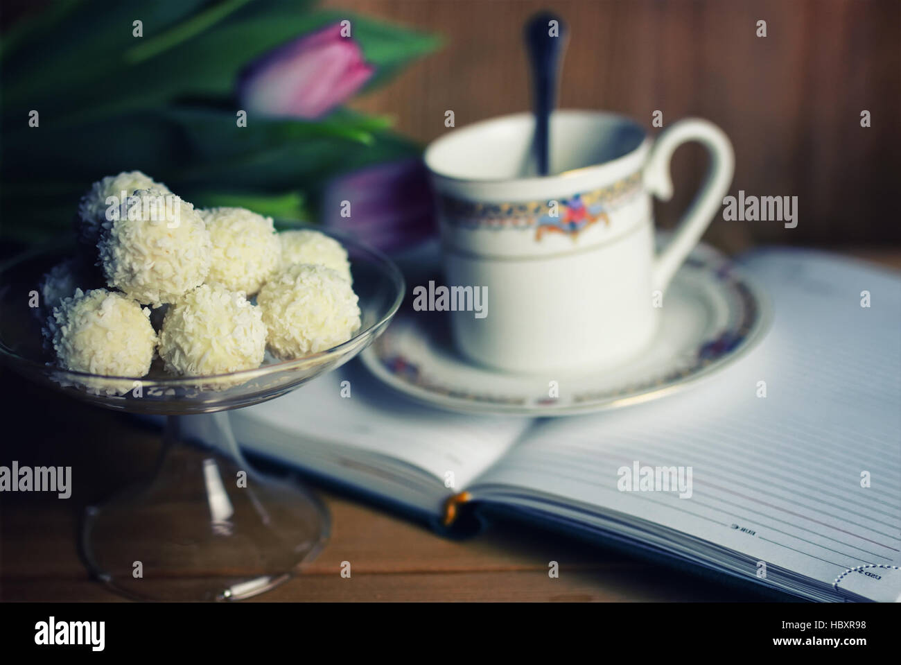 reading book with tea flower and sweet Stock Photo - Alamy