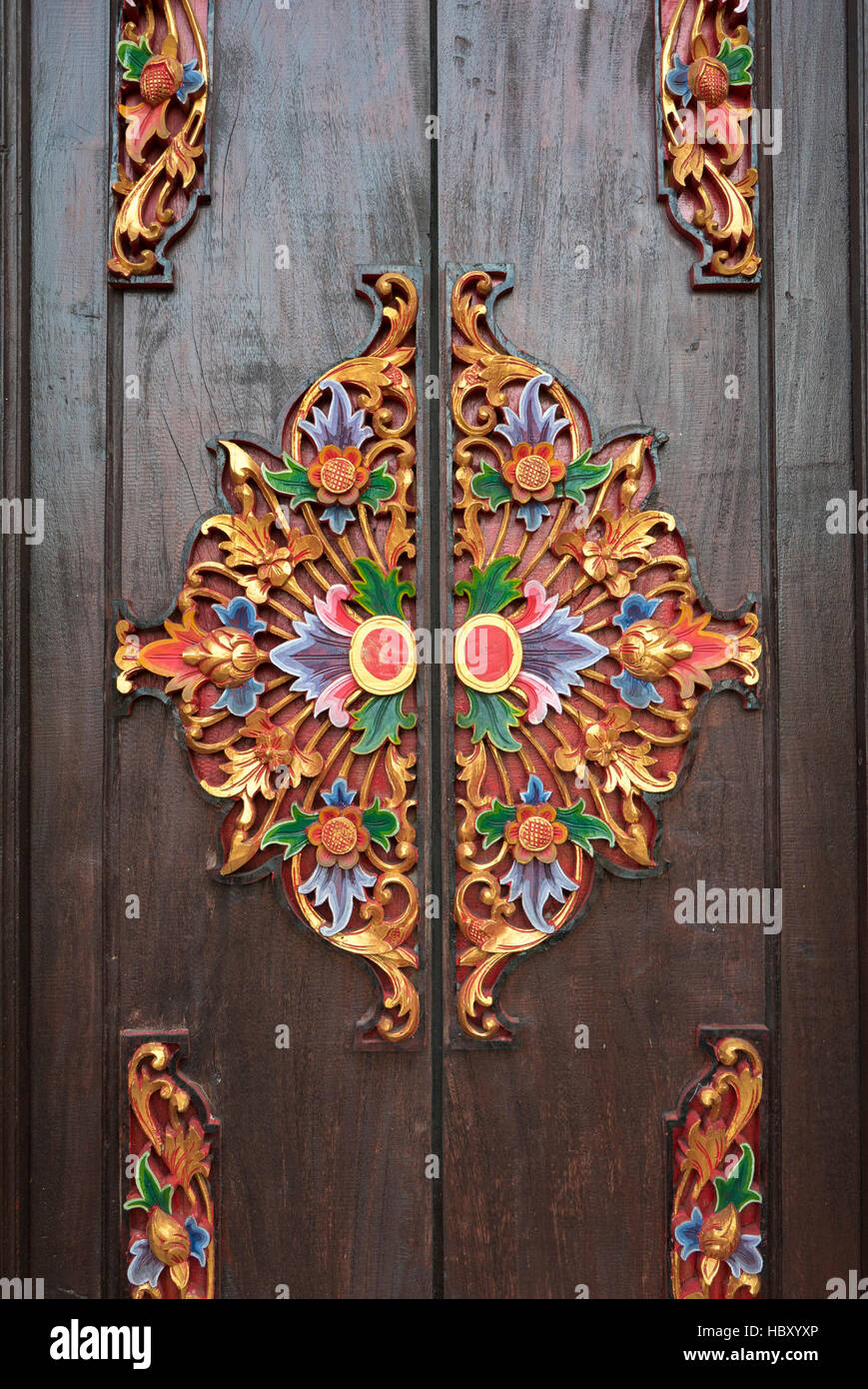 Details of wooden ornate entrance door to temple In Bali. Indonesia Stock Photo