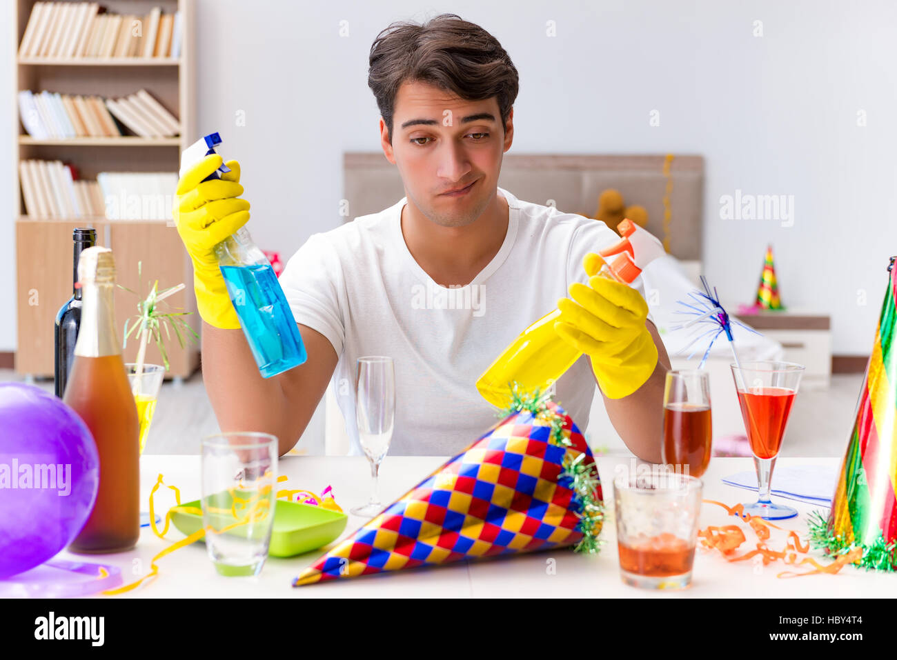 Man cleaning the house after christmas party Stock Photo - Alamy