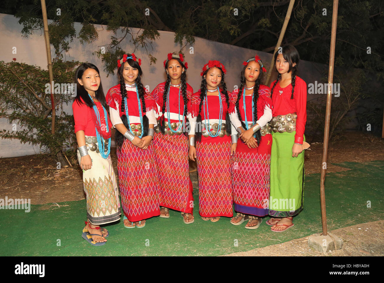 A group of Nishi tribal female dancers from Arunachal Pradesh, India standing in their traditional dance costumes . Ajmer,Rajasthan, India Stock Photo