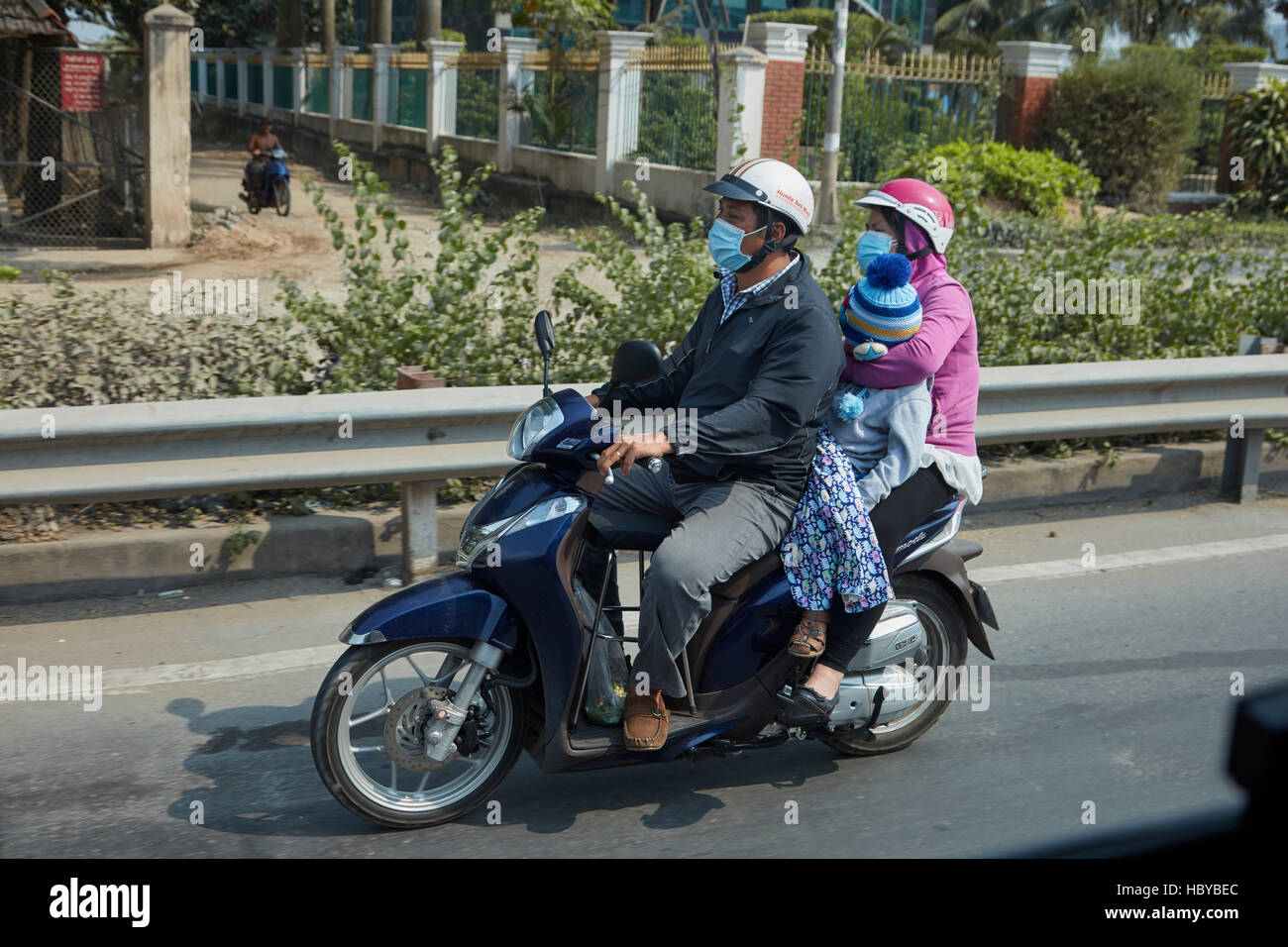 Familiy of three on scooter, Ho Chi Minh City (Saigon), Vietnam Stock Photo