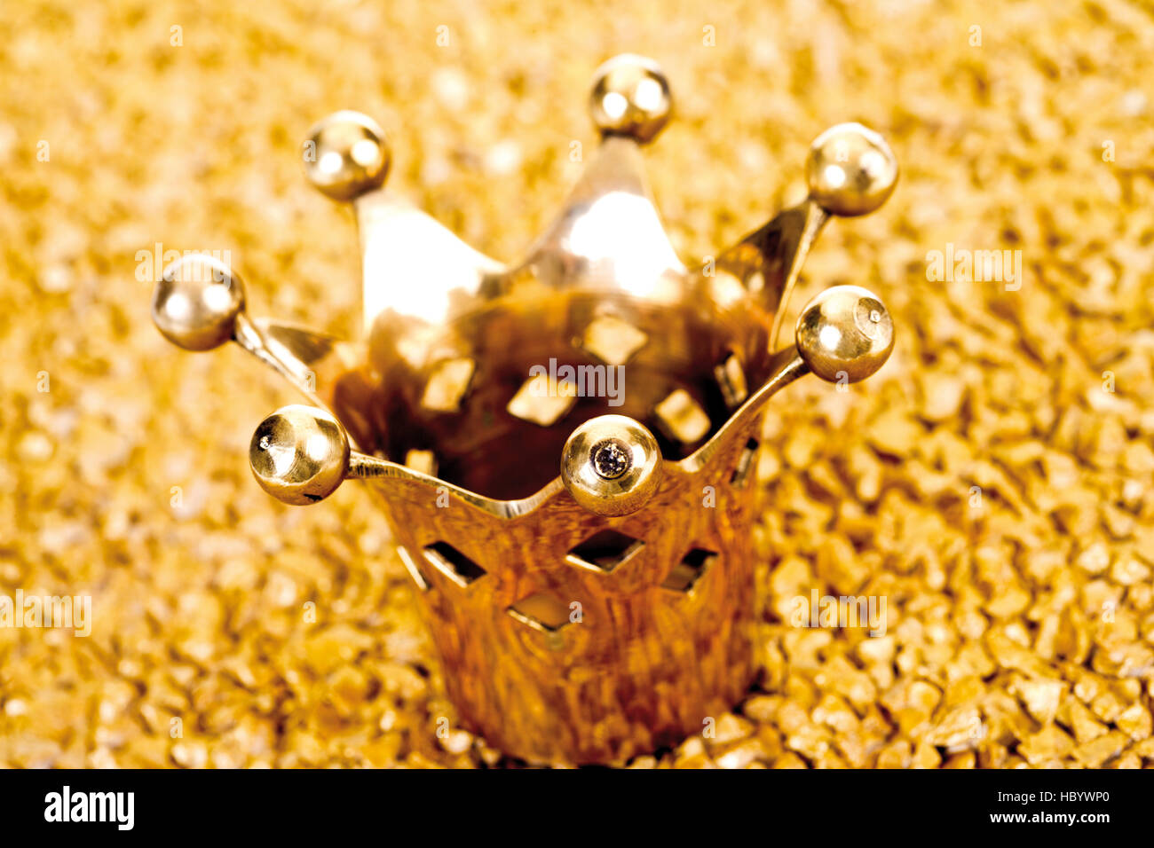 Golden crown on gold nuggets Stock Photo
