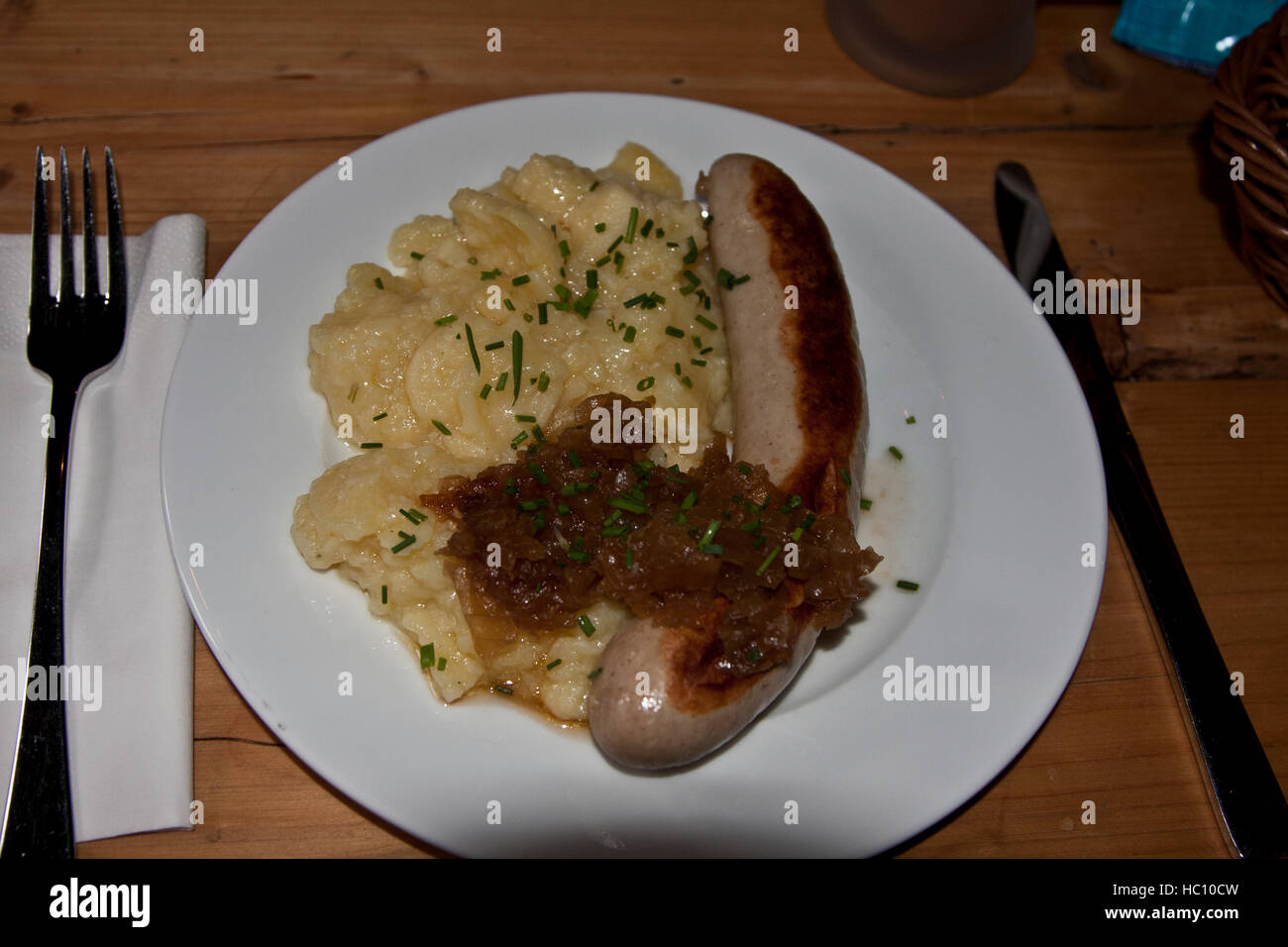 Christmas craft market at Ludwigsburg, Germany, traditional German holiday fare, a grilled bratwurst sausage with potato salad Stock Photo