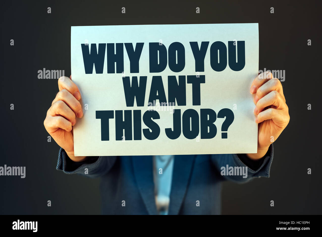 Why do you want this job question printed on paper held by business woman Stock Photo
