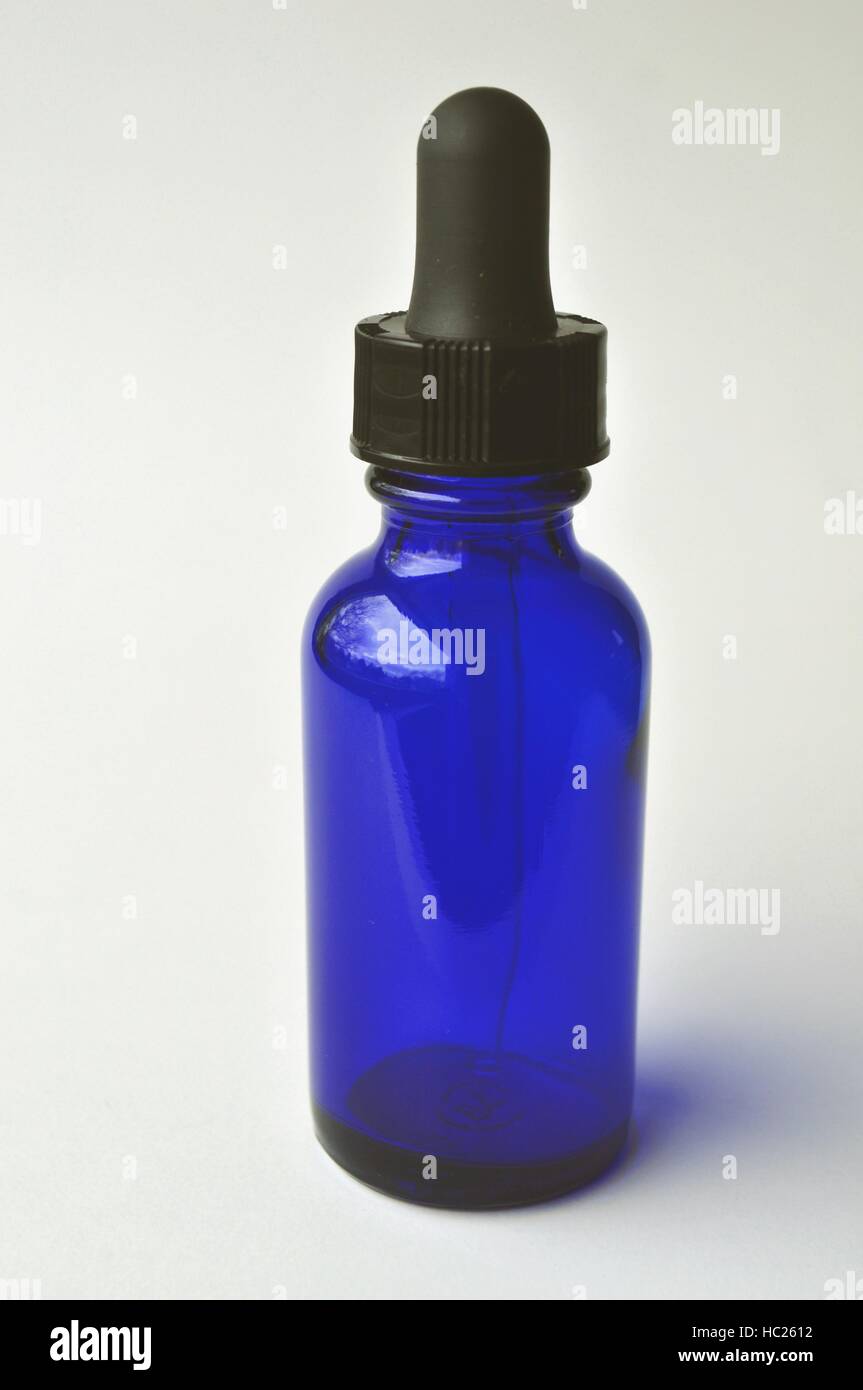Group of dark blue cosmetic glass bottles for essential oils