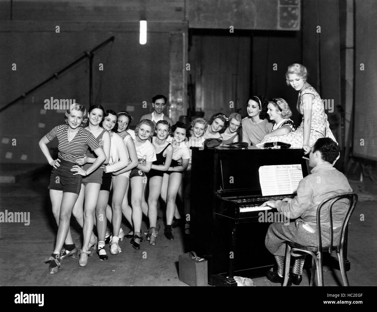 NIGHT WORLD, choreogapher Busby Berkeley, (back) rehearses dancers ...