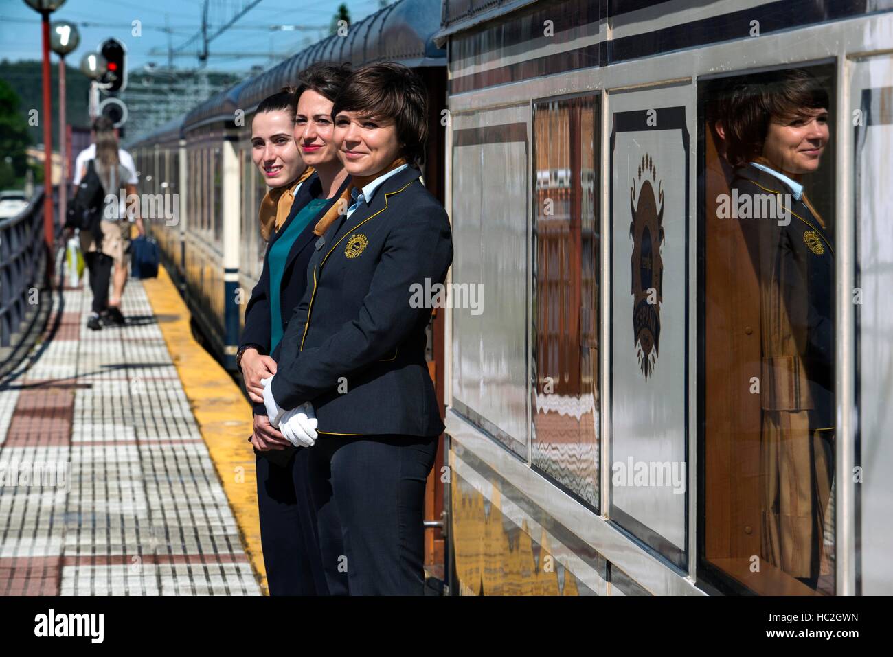 Outside of Transcantabrico Gran Lujo luxury train travellong across northern Spain, Europe. Hostesses receiving the passengers in Cabezon de la Sal, C Stock Photo