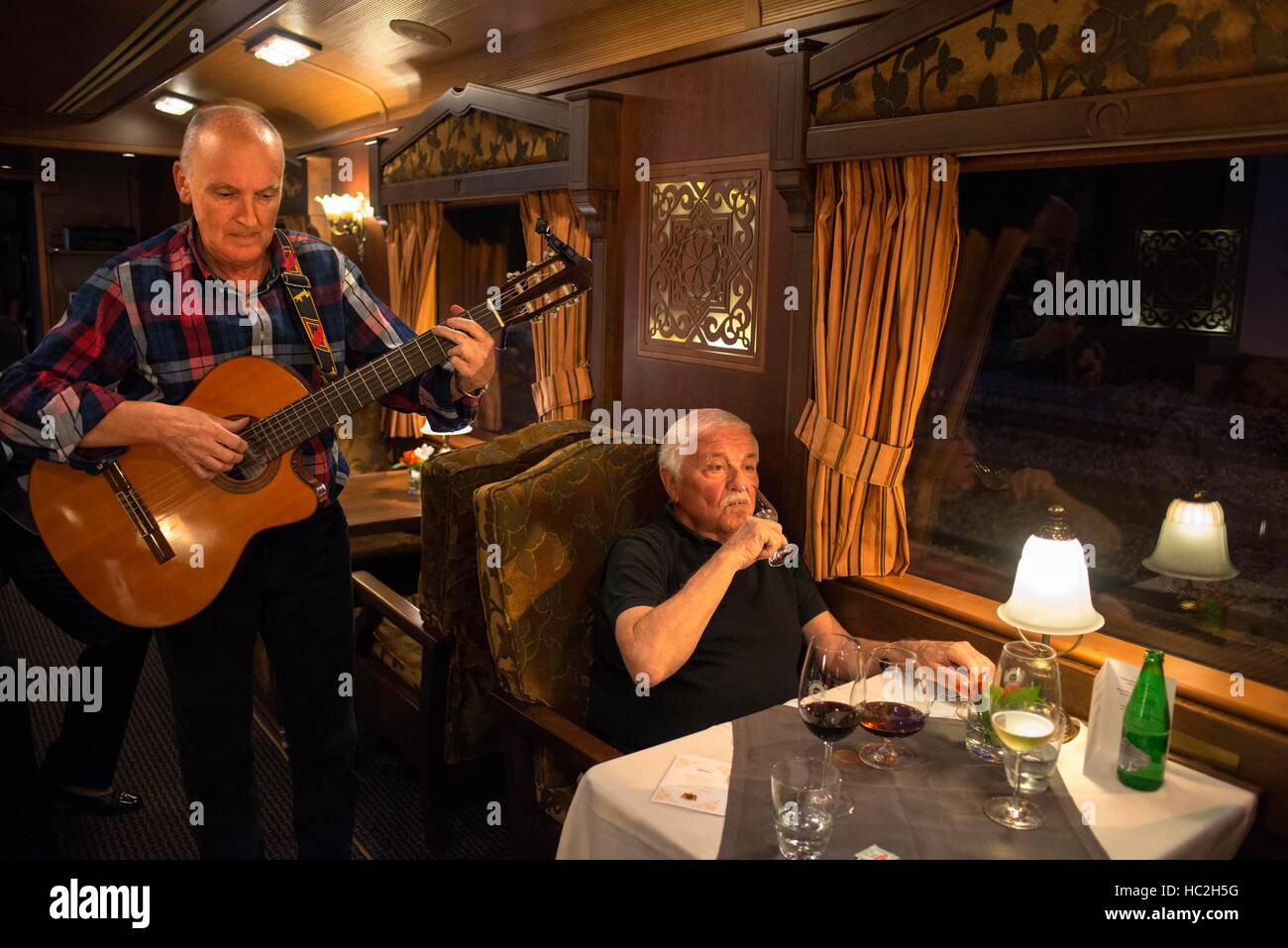 Inside of Transcantabrico Gran Lujo luxury train travellong across northern Spain, Europe. Interior of restaurant car. Guitar live music. Stock Photo