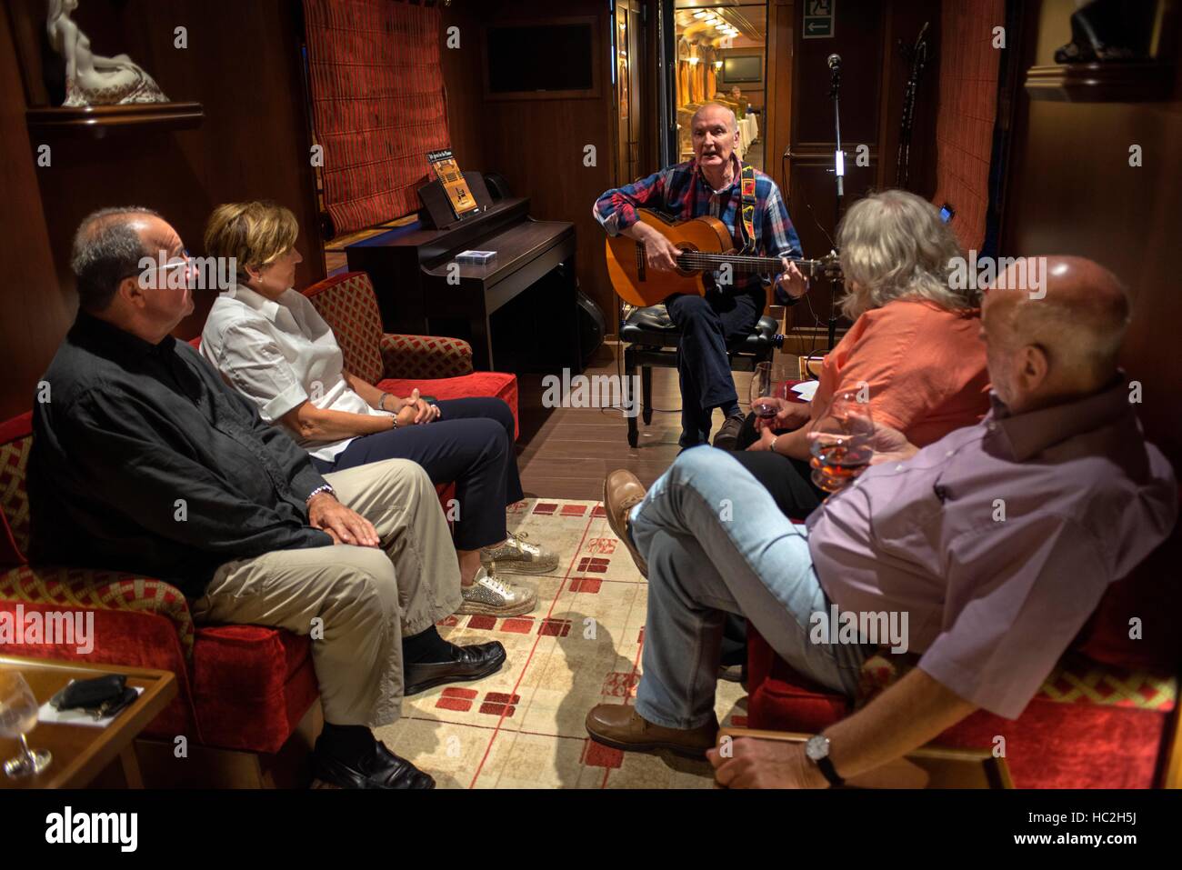 Inside of Transcantabrico Gran Lujo luxury train travellong across northern Spain, Europe. Interior of discotheque car. Guitar live music. Stock Photo