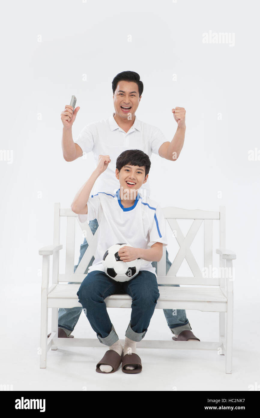 Loving father and son cheering with a soccerball Stock Photo