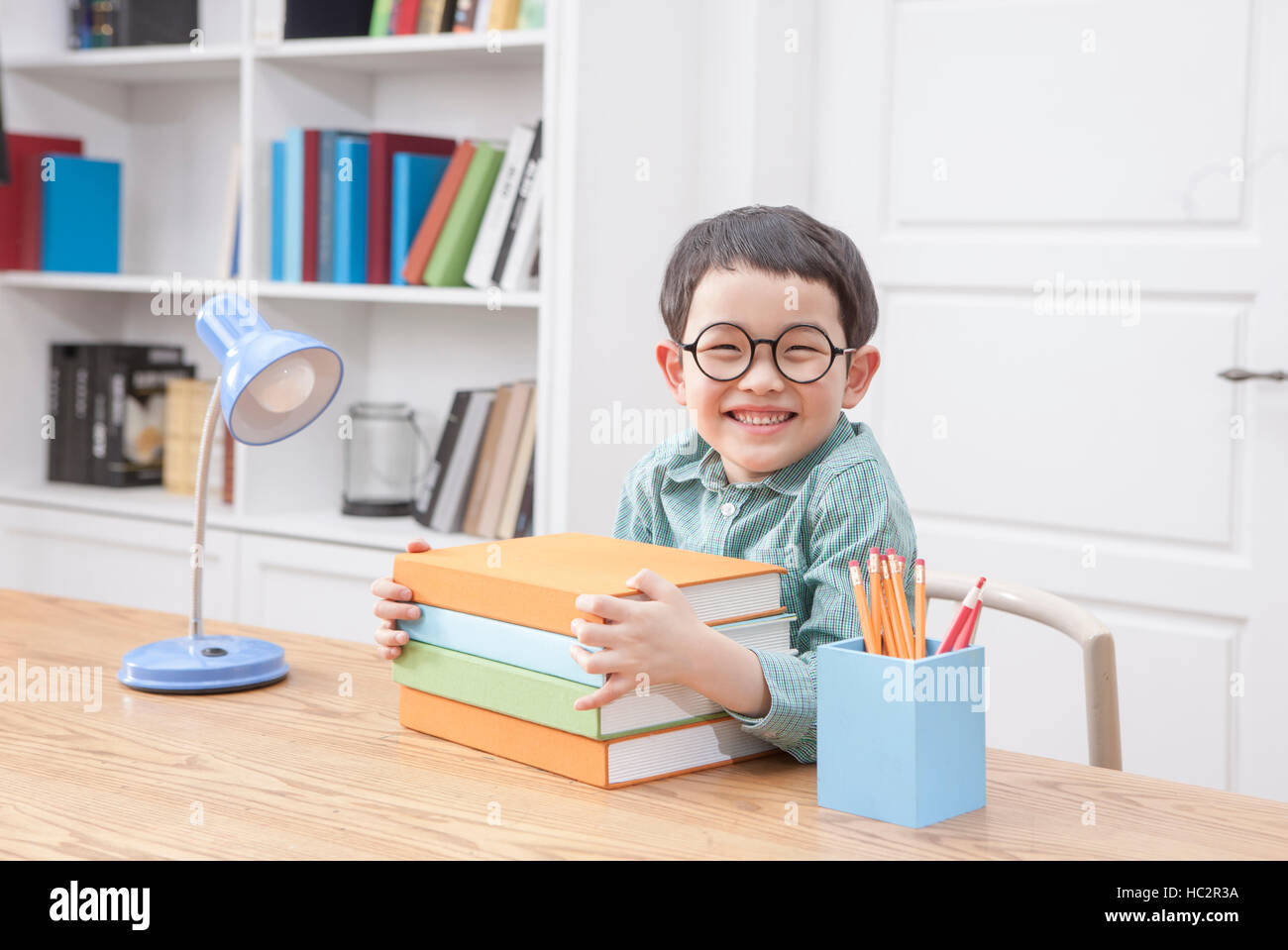 Boy holding books hi-res stock photography and images - Alamy