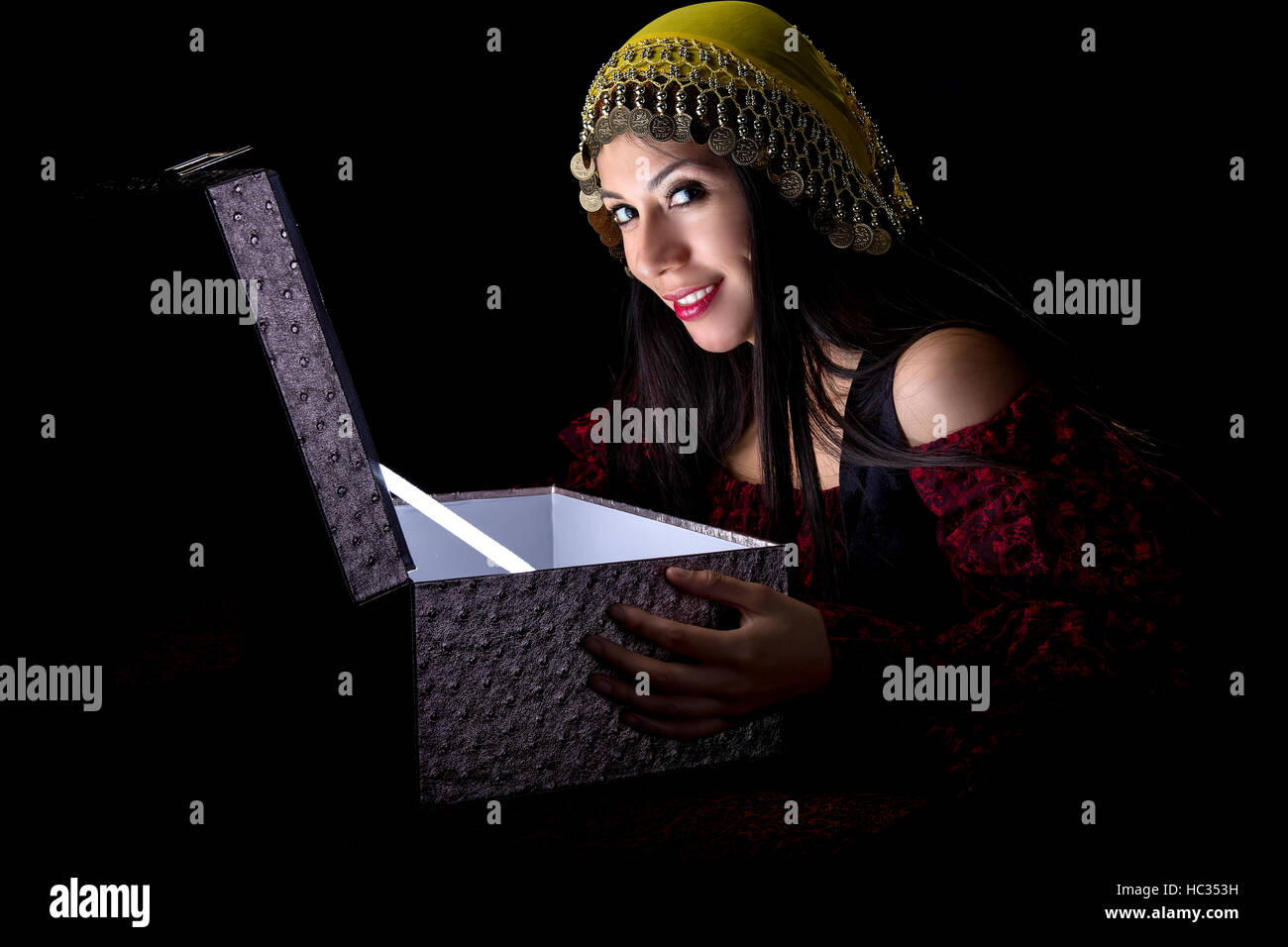 Fortune teller or gypsy opeing a glowing mysterious box and discovering