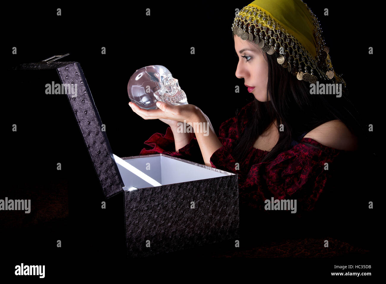 Fortune teller or gypsy opening a glowing mysterious box and