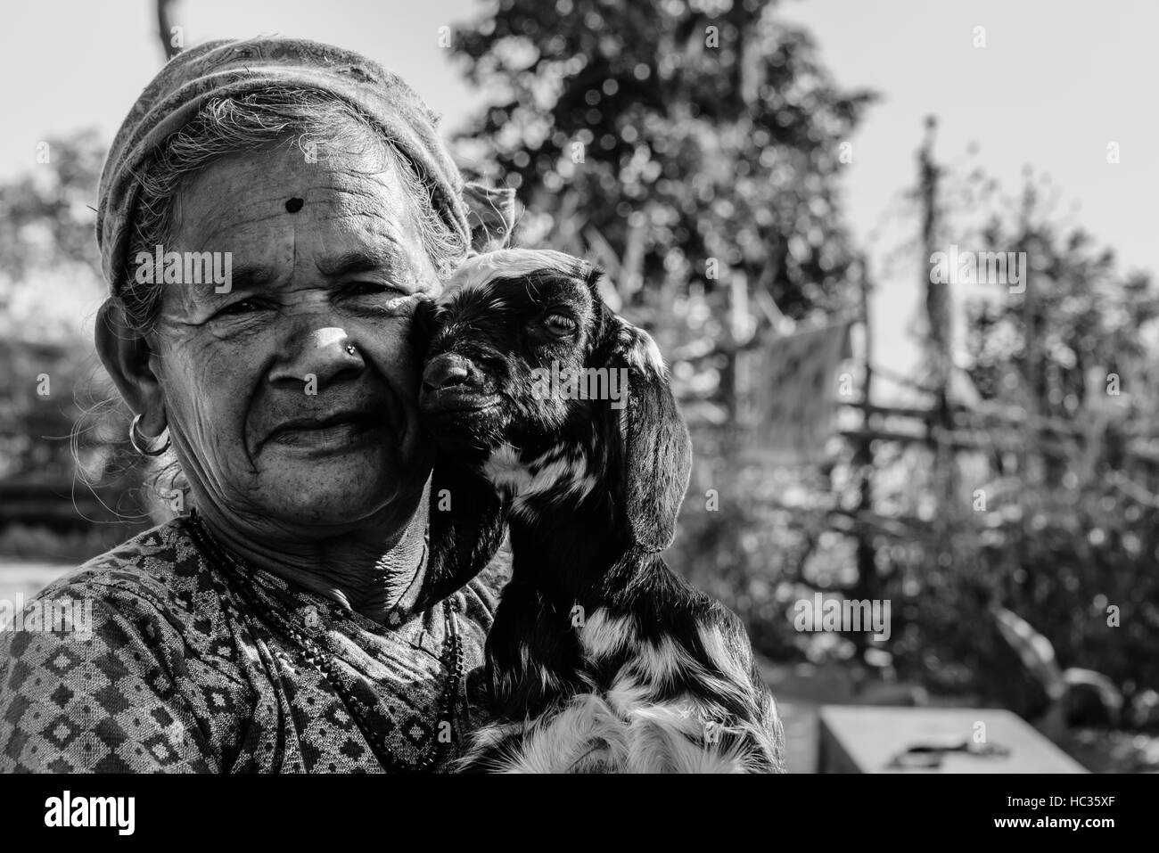 Nepalese lady with her baby goat - black & white Stock Photo